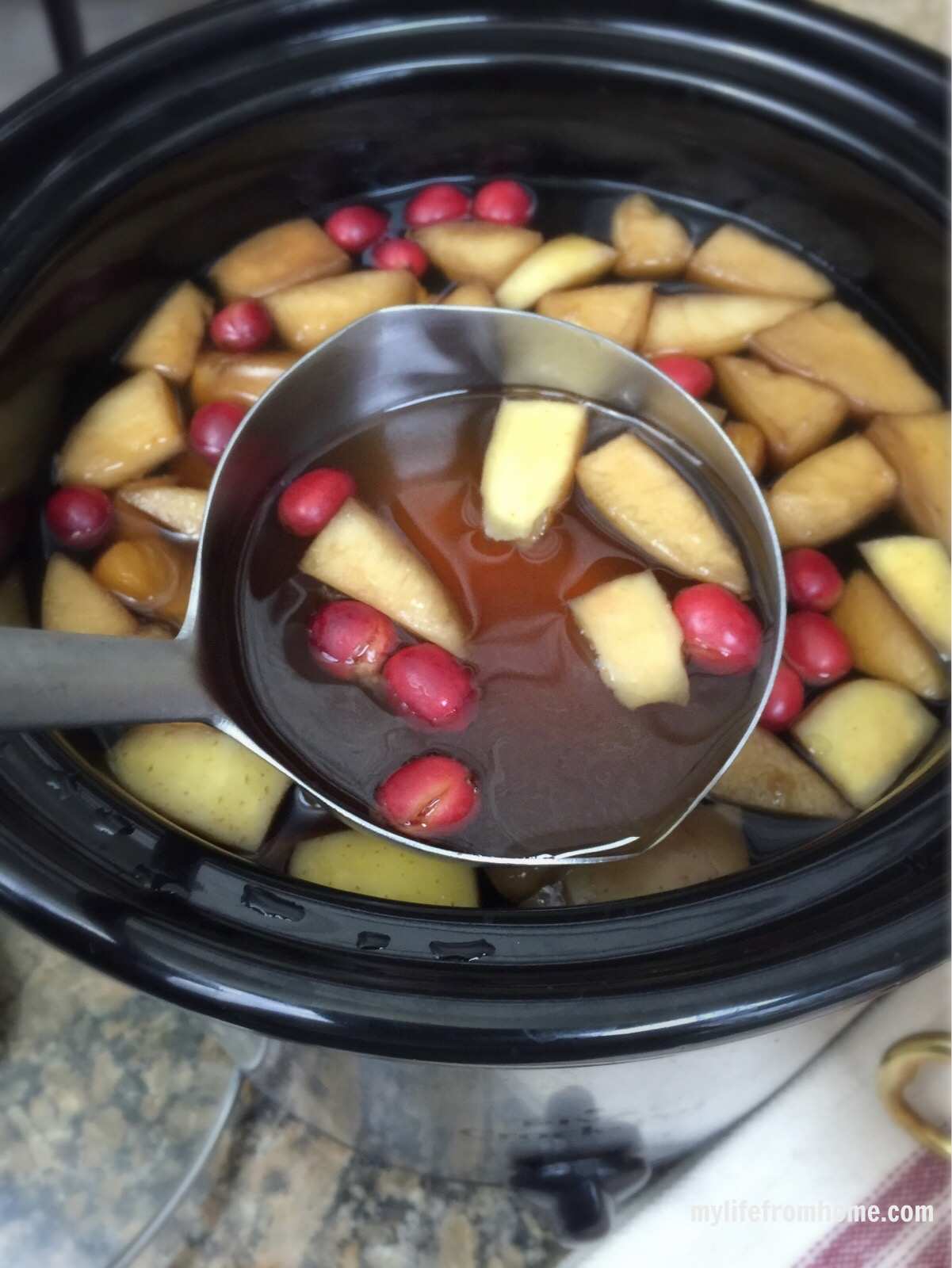 Fruit and cinnamon infusing in warm tea for a festive gathering
