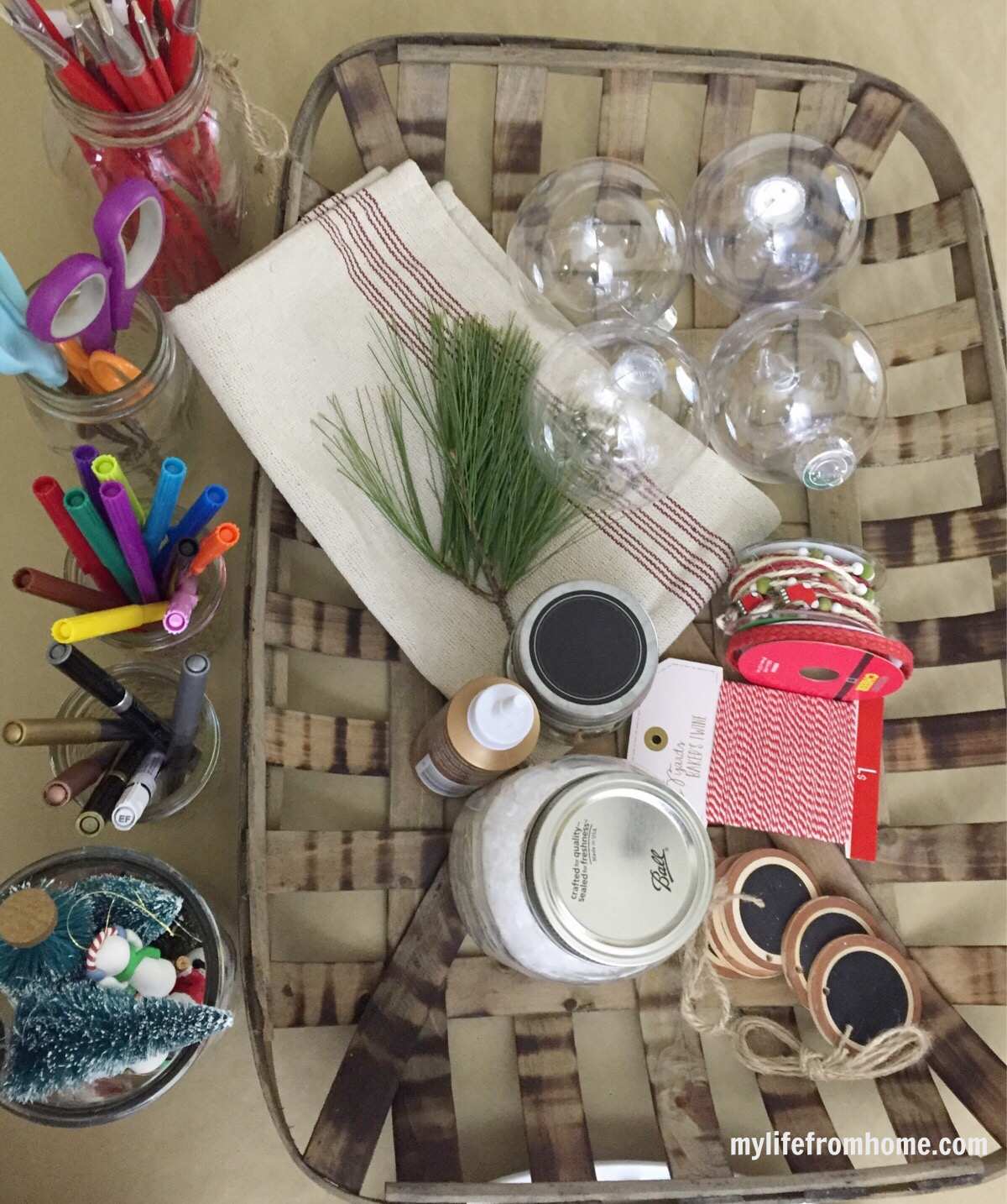 Small jars holding ribbons and Christmas craft embellishments