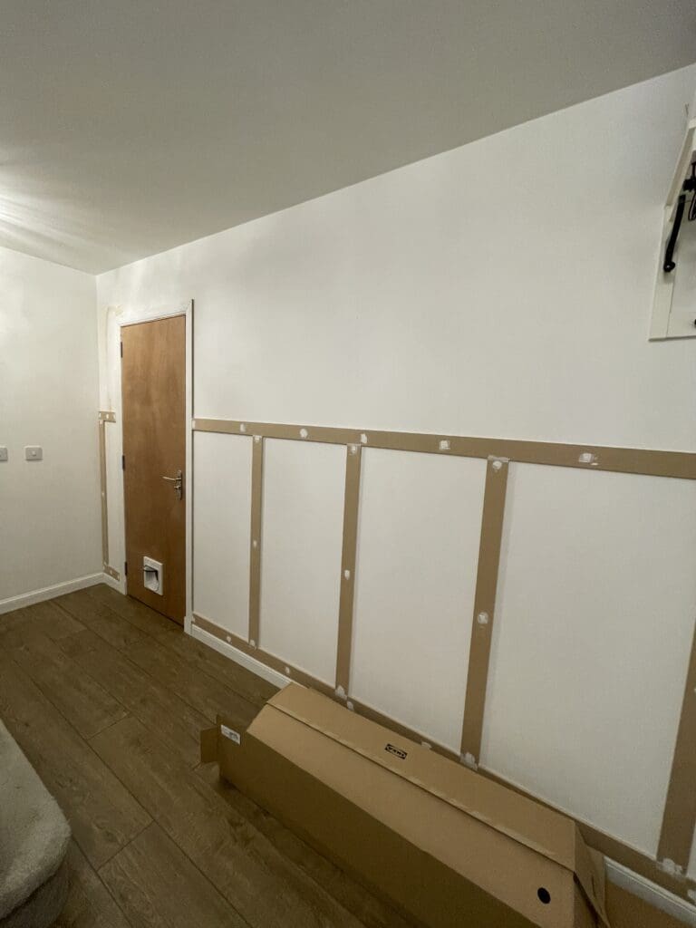 MDF wall panelling being installed in hallway showing battens screwed to wall before filling and painting