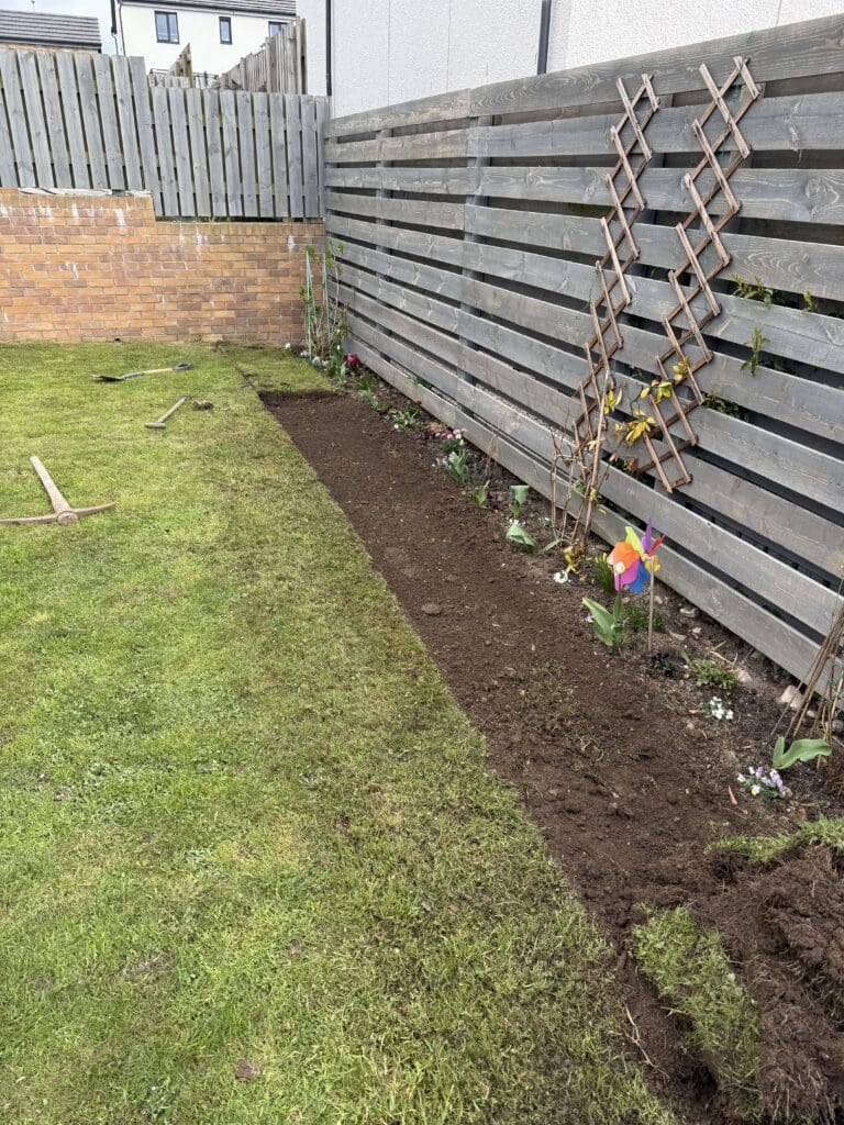 digging out a flowerbed in a new-build garden